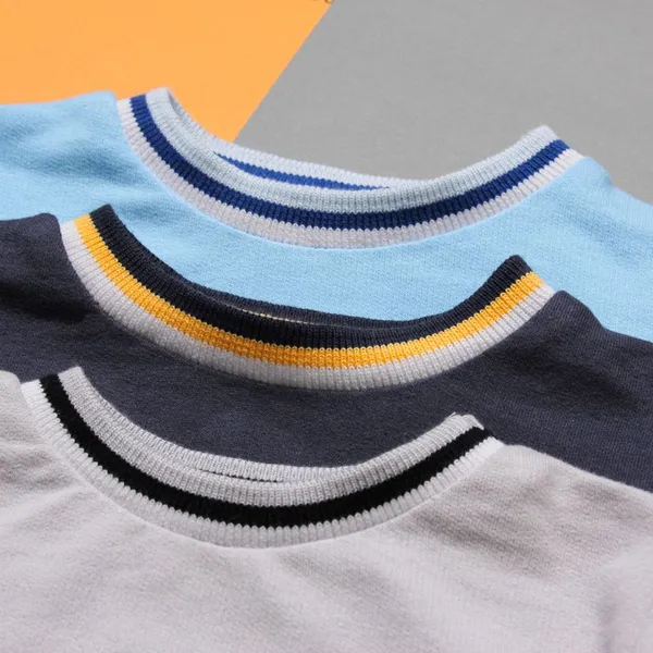 Three sweatshirts stacked, showing their contrast-striped rib collars.