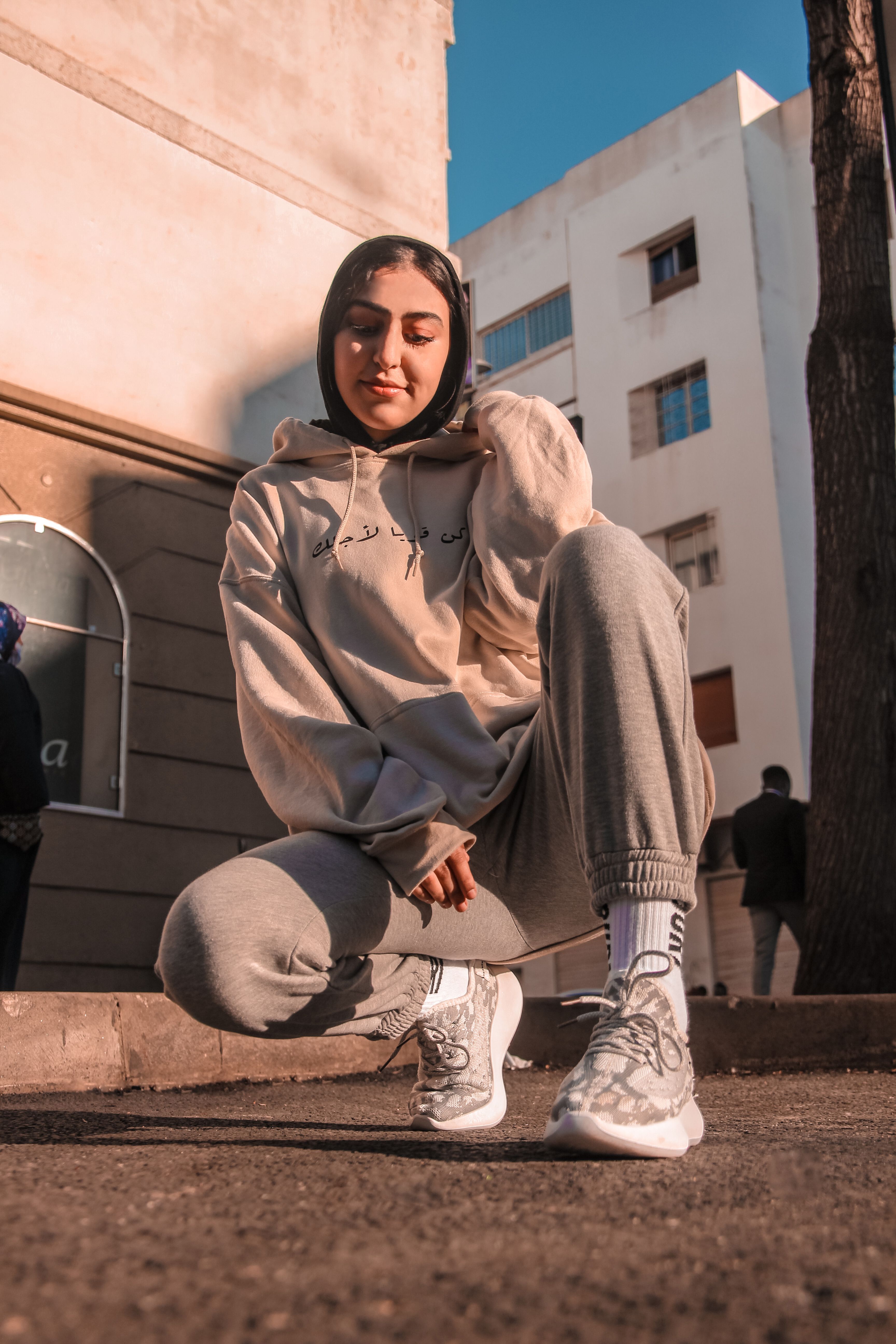 A person wearing a matching hoodie and joggers set.