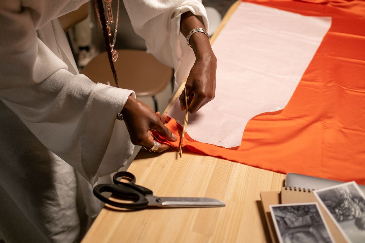 Fabric being cut to pattern on a cutting table.